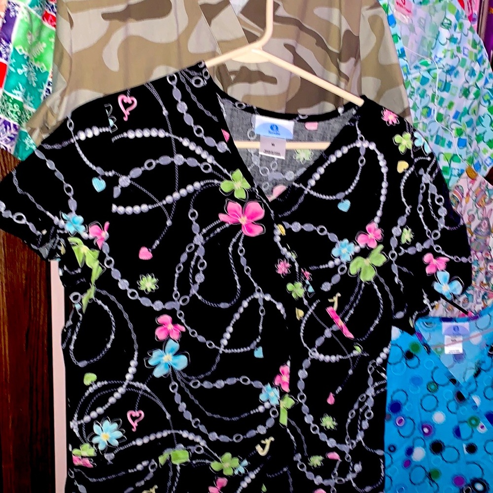 Several multicolor and seasonal scrub tops